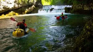 Kayak through lush forests and rolling hills